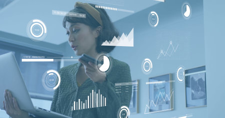 Image of data processing over asian businesswoman working at office. Global business and digital interface concept digitally generated image.の写真素材