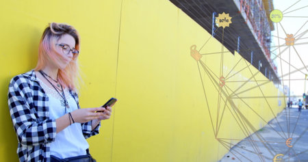 Image of network with digital icons over woman using smartphone. global social media, digital interface, technology and networking concept digitally generated image.の写真素材