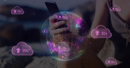 Cloud upload icon and spinning globe against mid section of woman using smartphone. global...