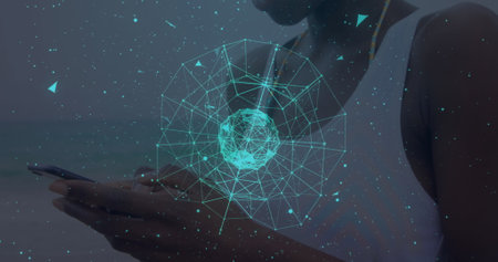 Globe of network of connections against african american woman using smartphone. global networking and technology conceptの写真素材