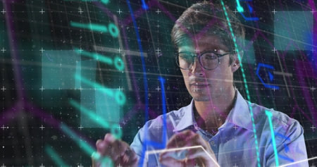Image of neon shapes over caucasian man using touchscreen. Business, network, data processing, digital interface and technology concept digitally generated image.の写真素材