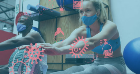Image of covid-19 icons over diverse group wearing face masks working out. global covid 19pandemic concept digitally generated image.の写真素材