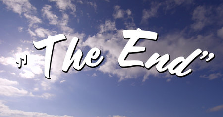 Digital image of a white The End sign appearing in the screen with a background of the sky with clouds during the dayの写真素材
