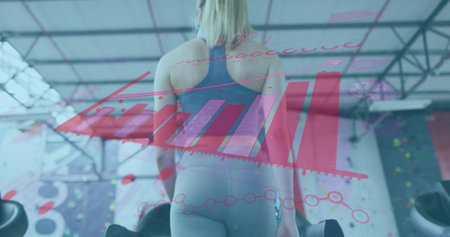 Image of graphs and statistics over caucasian woman wearing face masks working out. global covid 19pandemic concept digitally generated image.の写真素材