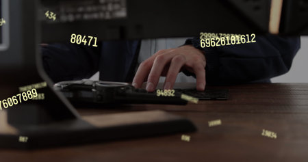 Image of floating numbers over caucasian businessman working. global science, technology and digital...