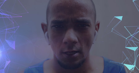 Image of glowing purple and blue networks over portrait of determined male athlete exercising....