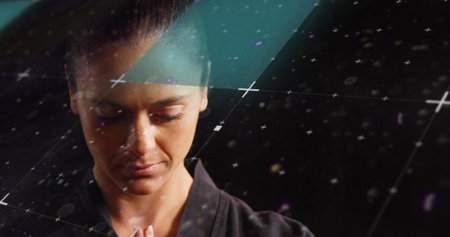 Image of scanner processing data over female martial artist. sport, competition and technology concept, digitally generated image.の写真素材