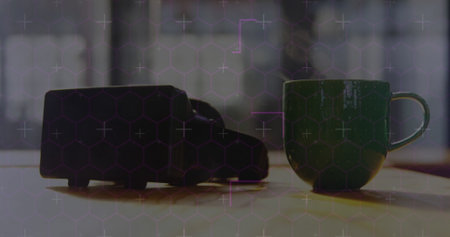 Hexagonal shapes and light trails against hot coffee and vr headset near the window at home....
