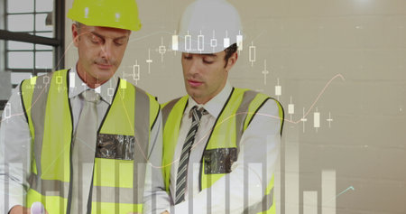 Two male architects discuss plans with graphs.