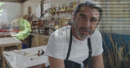 Two men building in a workshop with graphs and stats.