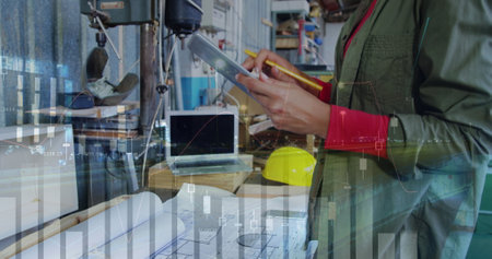 Female engineer plans with tablet, graphs in shop.
