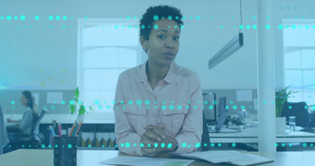 Image of data processing over african american businesswoman talking in office. Global business and...