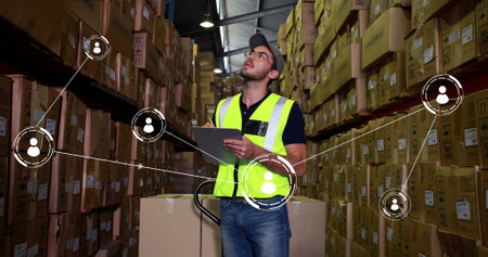 Image of network of conncetions with icons over caucasian male worker taking notes in warehouse....