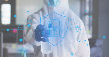 Image of digital padlock over man wearing safety suit and disinfecting office. global business and...