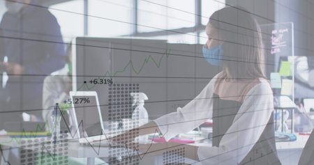 Image of financial data processing over asian businessman with face mask disinfecting in office....
