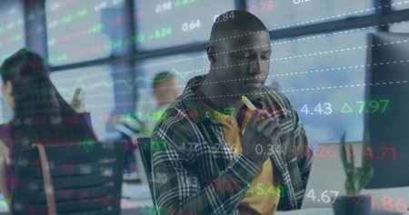 Image of financial data processing over african american businessman working in office. Global...
