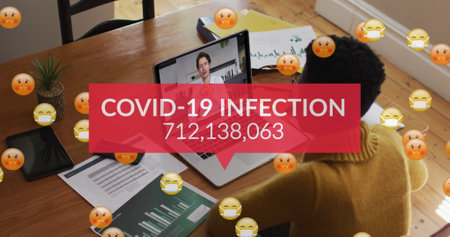 Image of emojis in face masks, number of covid 19 cases over woman using laptop on image call. Digital interface global covid 19 pandemic and connection concept digitally generated image.の写真素材