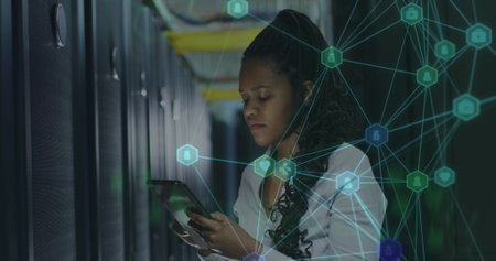 Image of network of connections over female african american server room worker. Cloud computing...
