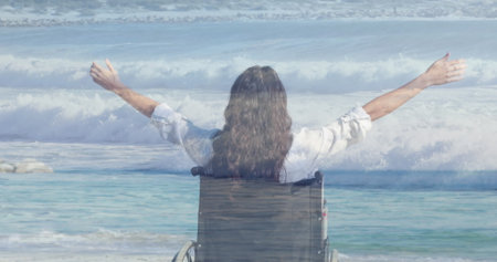 Image of sea landscape over disabled biracial woman sitting in wheelchair. International day of...
