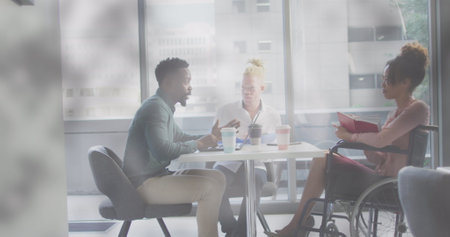 Image of globe over disabled african american woman with diverse business people. International day...