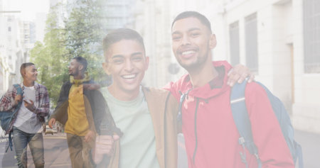 Composite of happy biracial male friends talking in street, and embracing wearing backpacks. travel, free time and friendship concept digitally generated image.の写真素材