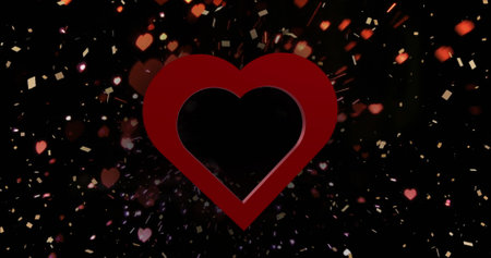 Image of red heart over light spots and confetti on black background. Valentine&#39;s day, love and celebration concept digitally generated image.の写真素材