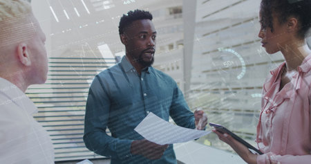 Image of data processing over diverse business people in office. Global business, finances, computing and data processing concept digitally generated image.の写真素材