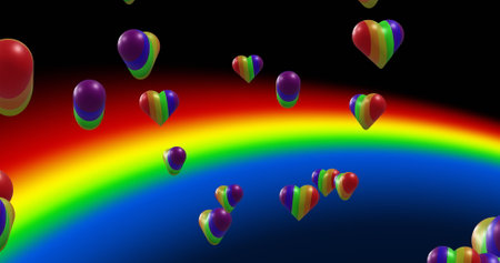 Image of rainbow hearts moving over rainbow on black background. Valentine&#39;s day, love and celebration concept digitally generated image.の写真素材