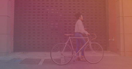 Asian woman with bicycle using smartphone while walking on the street. Technology and people conceptの写真素材