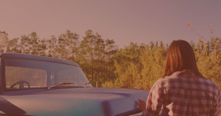 Caucasian woman getting out of the car and opening the hood on the street. Travel and roadtrip conceptの写真素材