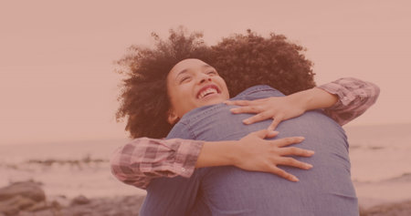 Happy african american couple hugging each other at the beach. Couple, relationship and vacation conceptの写真素材