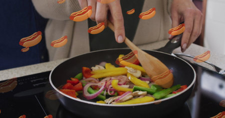 Image of hot dogs icons with senior caucasian couple cooking. food and baking concept digitally generated image.の写真素材