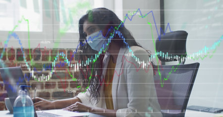 Image of financial data processing over businesswoman wearing face mask. global business, finances,...