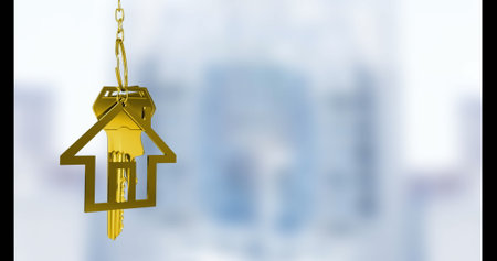 Image of key with house keychain over blurred background. Moving house concept digitally generated image.の写真素材