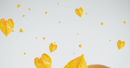 Image of leaves falling over pumpkins. Halloween, celebration and digital interface concept...