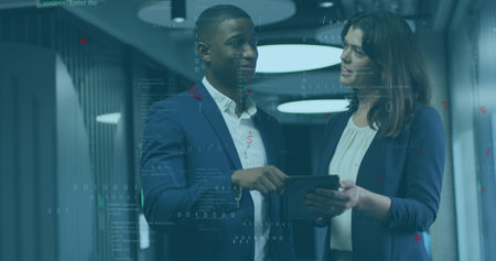 Image of data processing over diverse businessman and businesswoman discussing at office. Computer...