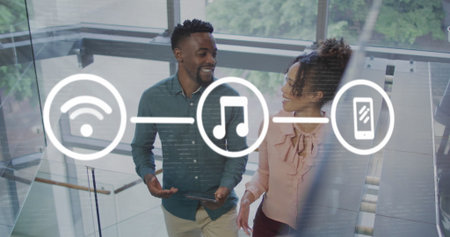 Image of icons connected with lines over diverse coworkers talking while climbing staircase. Digital...