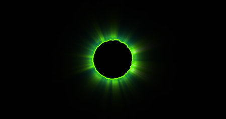 Bright green light encircling dark circle in center. Vivid display creating striking contrast against black backgroundの写真素材