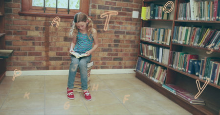 Caucasian girl wearing blue top and jeans, reading in school library. Blonde hair shining, red shoes on, focusing deeply on book with blue backgroundの写真素材