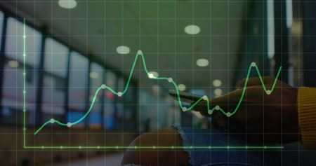 Image of graphs on grid pattern over midsection of african american man typing on cellphone. Digital composite, multiple exposure, report, business, three dimensional and technology concept.の写真素材