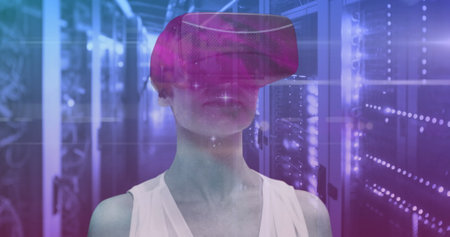 Caucasian female manager in VR headset, standing with short blonde hair. Wearing white top, she exploring virtual environmentsの写真素材