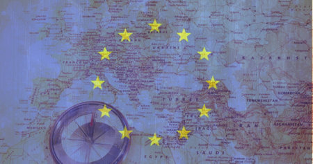 Compass resting on Europe map, yellow stars marking spots. Yellow stars highlighting countries on blue background, guiding travelersの写真素材