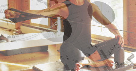 Woman in gray sports outfit practicing yoga on wooden floor. Sunlight streaming through large windows, creating warm ambianceの写真素材