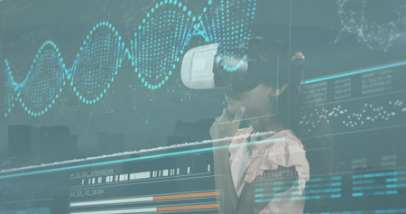 Biracial granddaughter wearing virtual reality headset, exploring digital graphs. Light brown skin,...