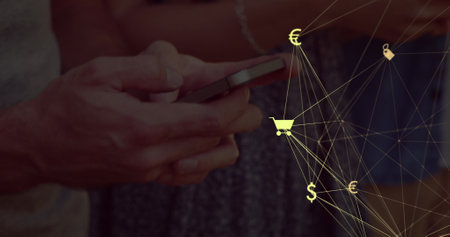 Man holding smartphone, exploring online shopping options. Golden lines and symbols of money encircle him on blue background. He's immersed in digital transactions, navigating through various financial optionsの写真素材