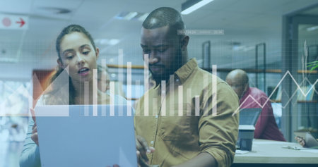 Image of financial data processing over diverse business people working in office. Global business, finances, computing and data processing concept digitally generated image.の写真素材