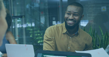 Image of financial data processing over diverse business people working in office. Global business, finances, computing and data processing concept digitally generated image.の写真素材