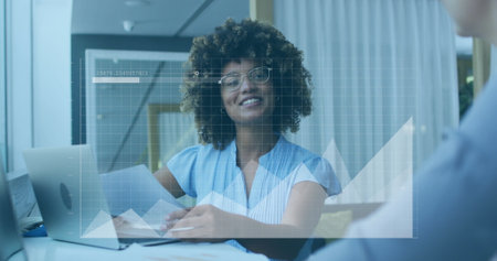 Image of financial data processing over diverse business people working in office. Global business, finances, computing and data processing concept digitally generated image.の写真素材