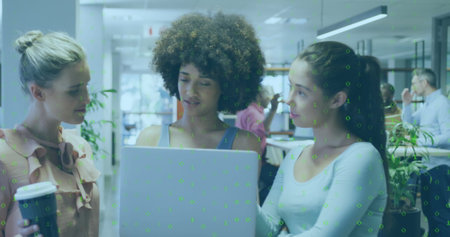 Image of binary coding data processing over diverse businesswomen working in office. Global business, finances, computing and data processing concept digitally generated image.の写真素材