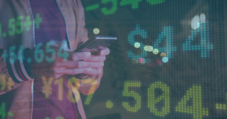 Image of stock market over caucasian businessman using smartphone. Global business and digital...